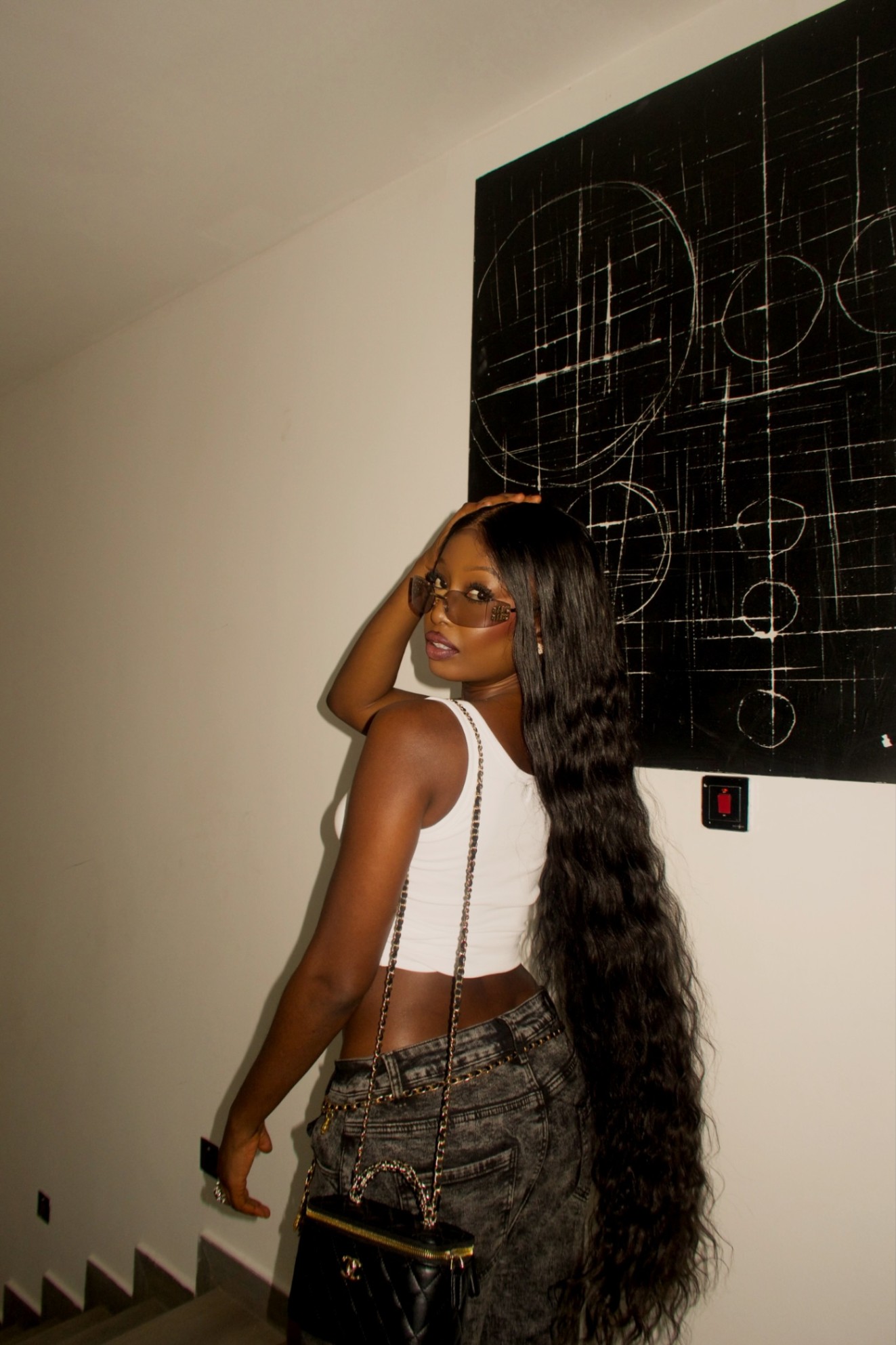 Model in long deep wave hair looking over her shoulder