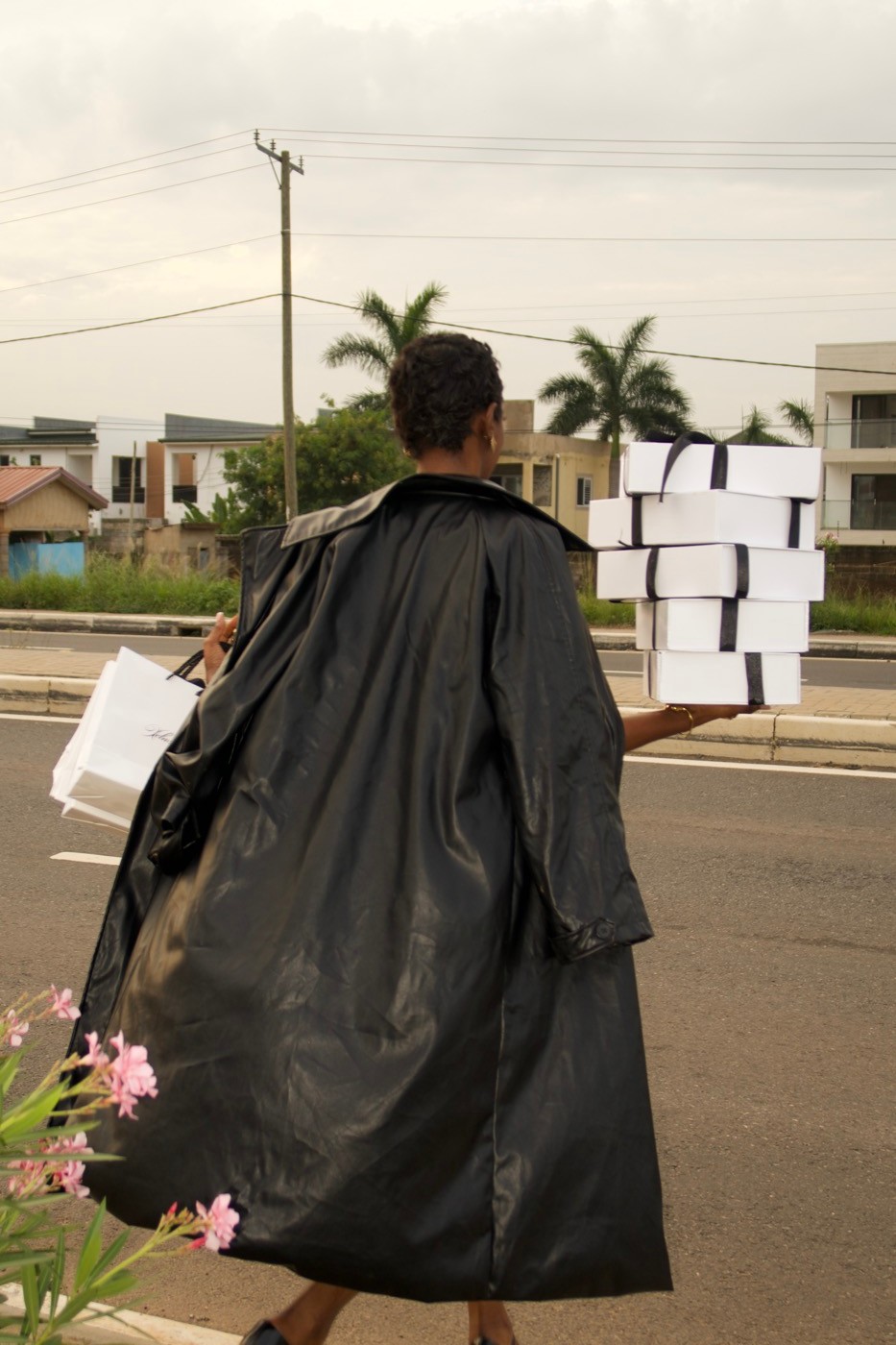 Model carrying a stack of Xclusive gift boxes