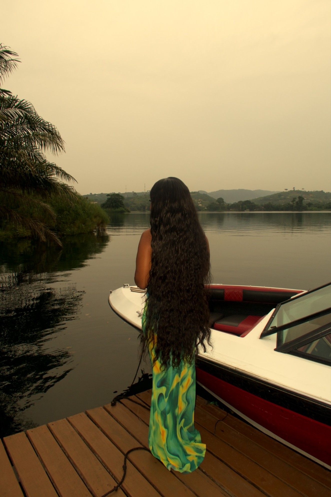 Model with floor-length hair on a jetty at dusk
